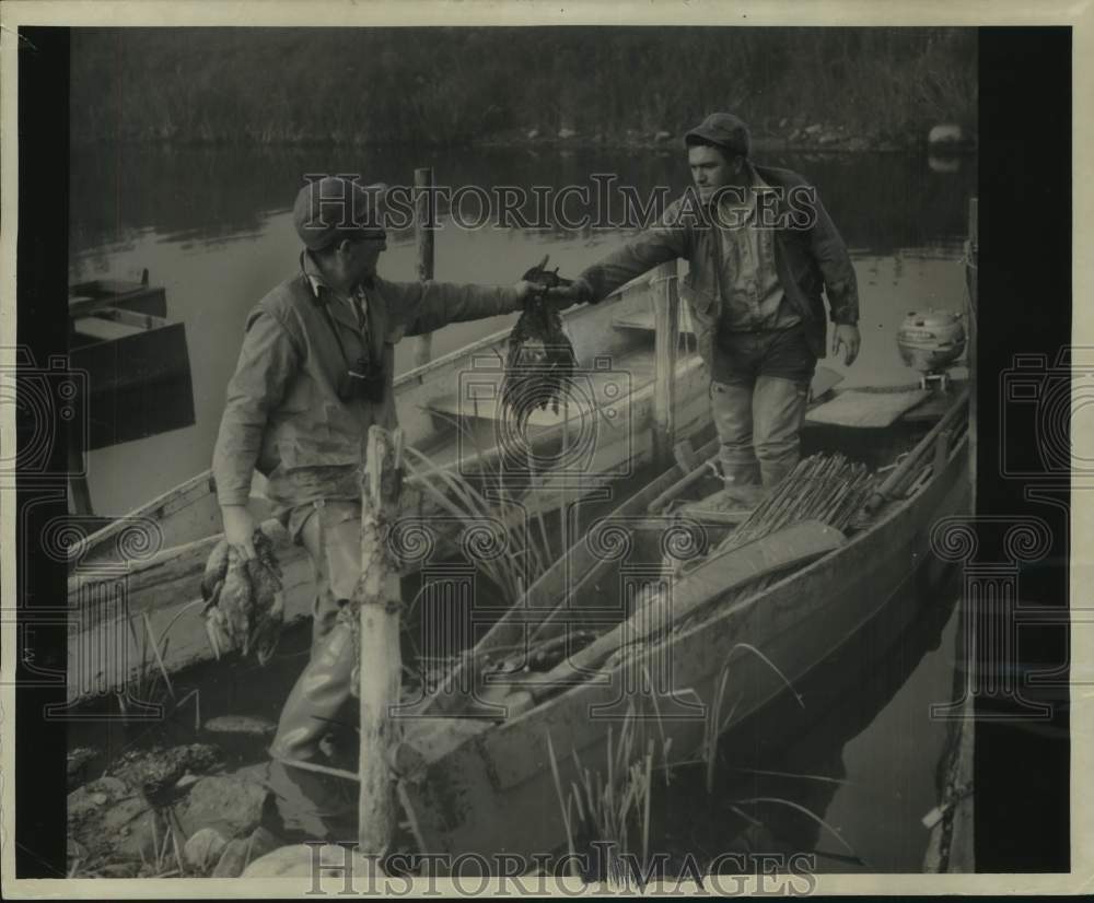 1957, Rudy and Gene Baack return in boat from duck hunting, Sheboygan - Historic Images