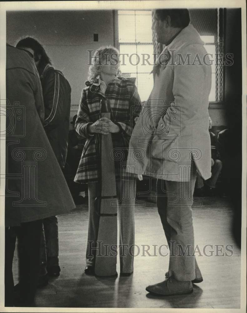 1975 Press Photo Woman waiting in line with gun case. - mjc37458 - Historic Images
