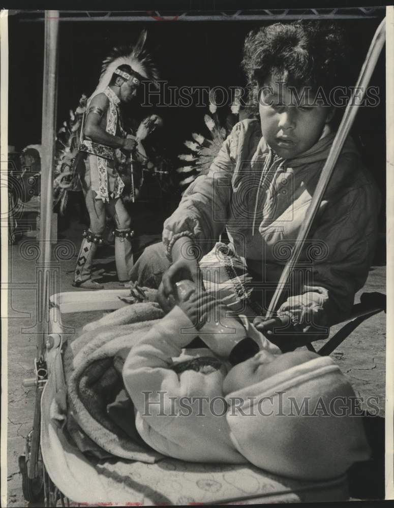 1964, Bonnie Cleveland takes care of her niece during Indian festival - Historic Images