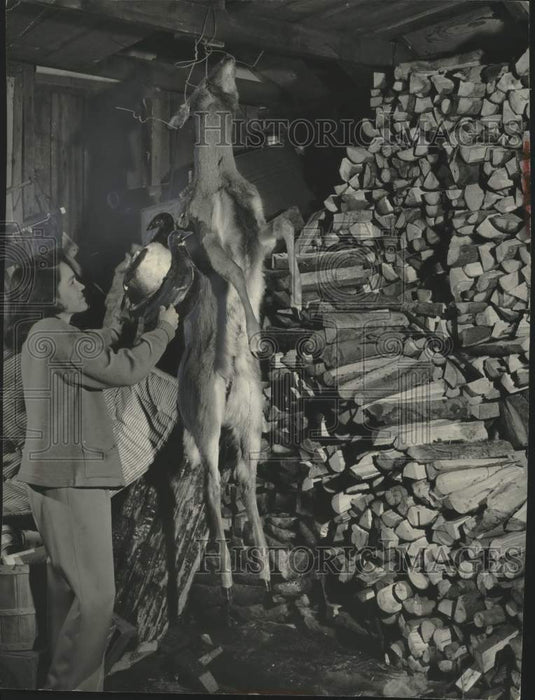 1950, Flora Christensen takes down a duck shot earlier for dinner - Historic Images