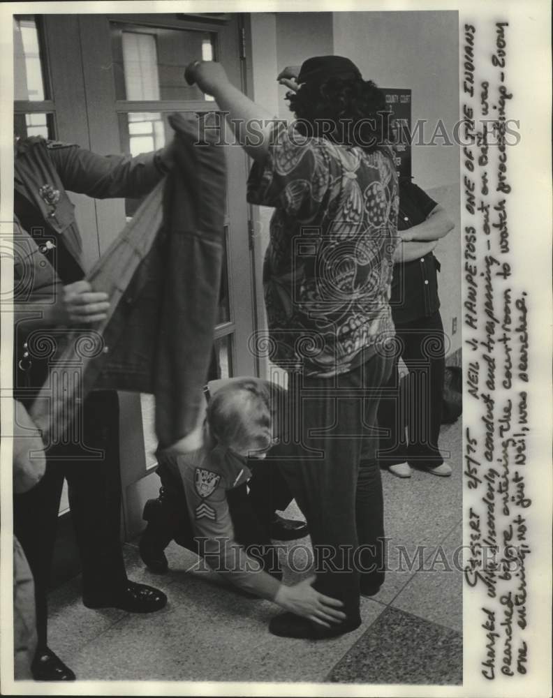 1975 Press Photo Neil Hawpetoss being searched before entering court, Wisconsin. - Historic Images