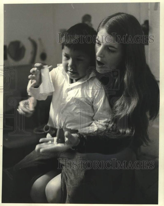1970, Lyntha shows a Havasupai Indian boy how a rocket works - Historic Images