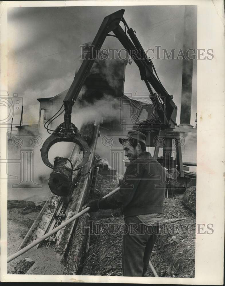 1963, Saw Mill worker Benjamin Perez loads a debarking machine, WI - Historic Images