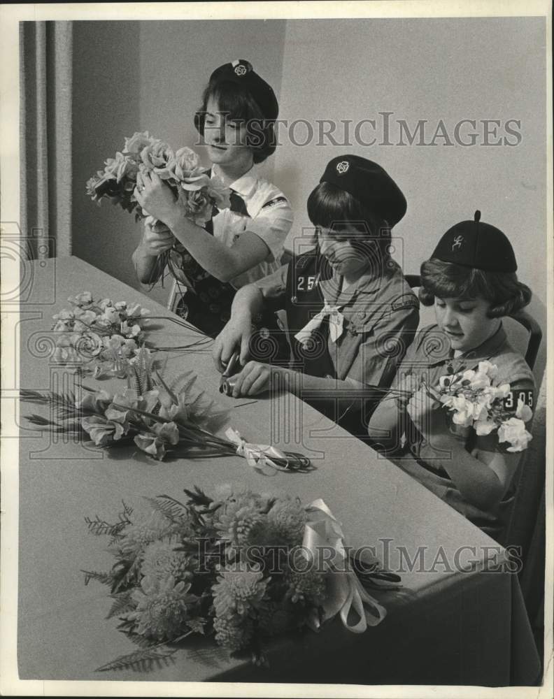 1966, Girl Scouts make bouquets of flowers for cemetery graves - Historic Images