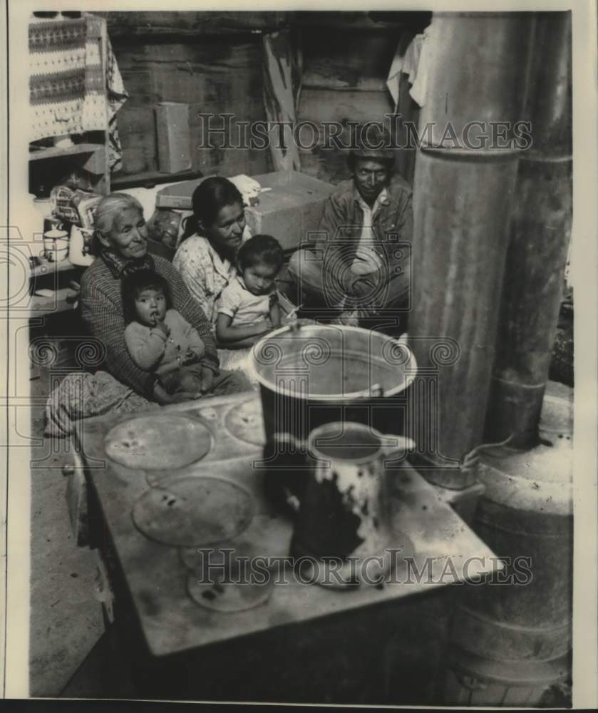 1968 Press Photo A Navajo sheepherder and his family sit by cook stove for heat - Historic Images