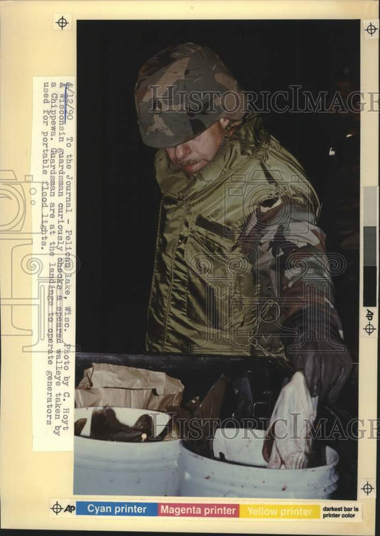 1990 Press Photo Pelican Lake-Guardsman checks out fish taken by a Chippewa - Historic Images