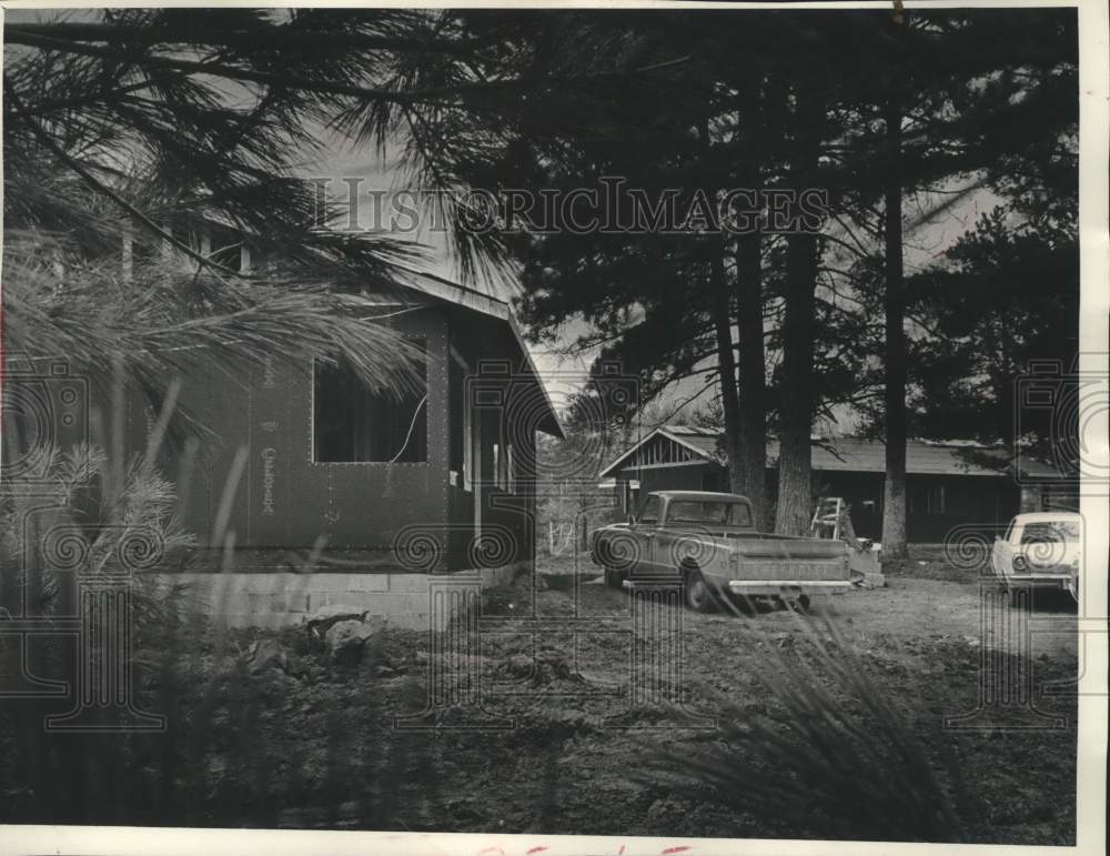 1973, Chippewa partially built duplexes under evergreen trees - Historic Images
