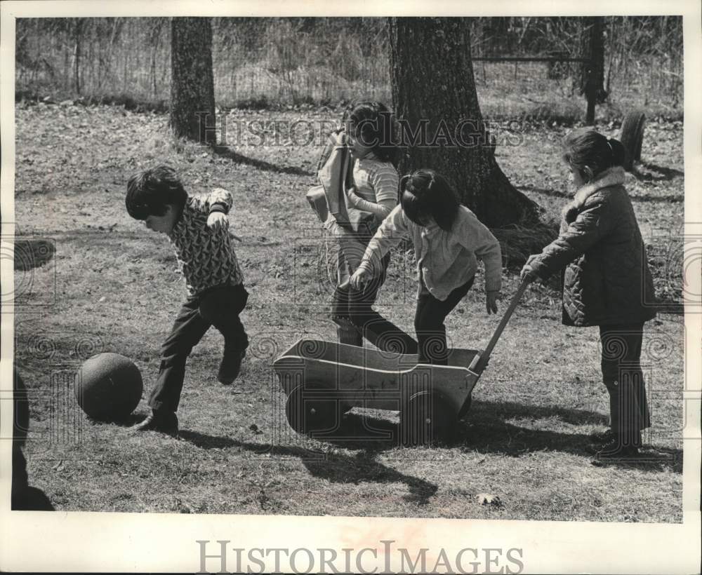 1973 Chippewa Indian children play by school building, Reserve. - Historic Images