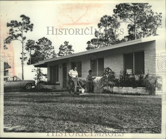 1962 Seminoles Willie and son keeps yard neat in Dania, Florida - Historic Images