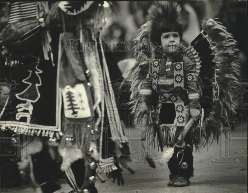 1983 Press Photo Child Follows Adult at United Indians of Milwaukee Powwow - Historic Images