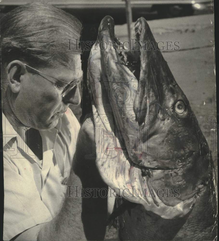 1951, Elbert Dixon holds up giant Muskie caught in Wisconsin - Historic Images