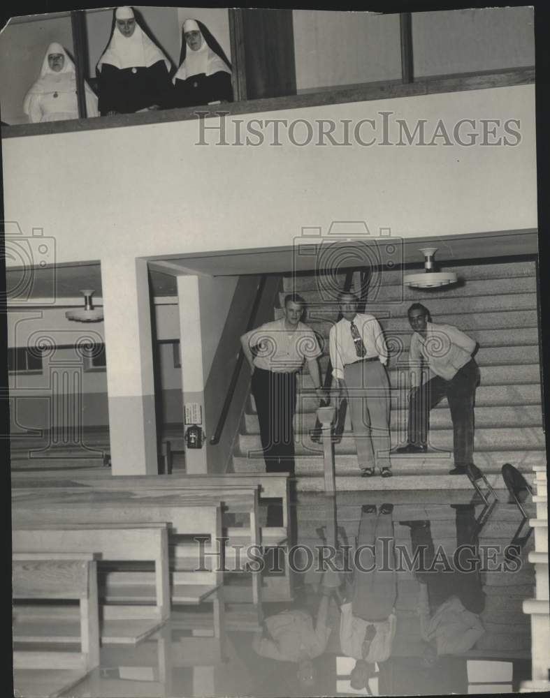 1952 Men view flood damage, Mother of Perpetual Help Catholic Churc - Historic Images