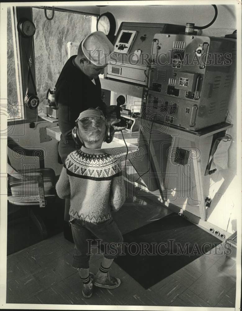 1965 Press Photo U.S Coast Guard shows a boy equipment in the radio shack, WI - Historic Images