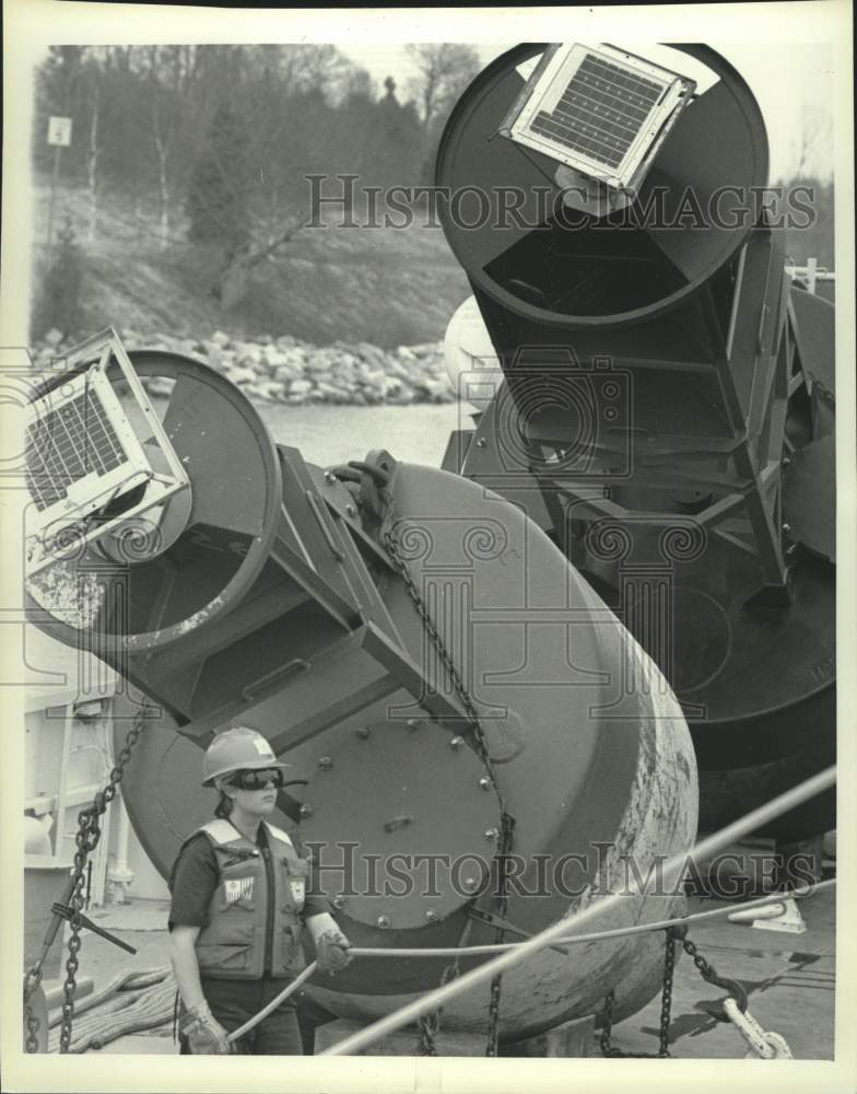 1993 Press Photo Navigational buoys dwarf Coast Guard member Tiffany Solberg - Historic Images