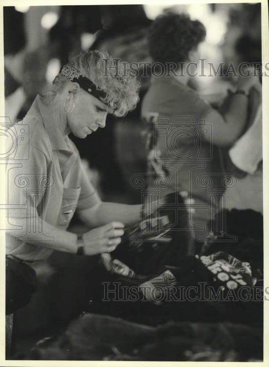 1993 Press Photo Gail Gerhartz looks at Harley-Davidson shirts, Summerfest, WI - Historic Images