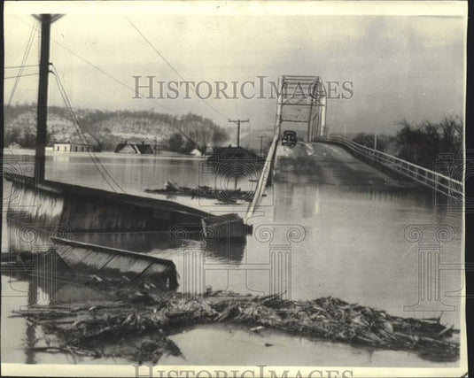 1937, house carried away by flooded Kentucky River stopped by bridge - Historic Images