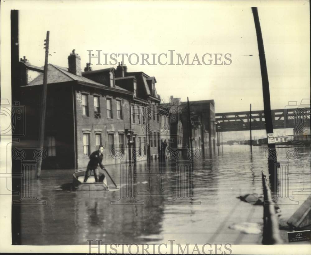 1936 Pittsburgh citizen relies on a rowboat on a flooded street - Historic Images