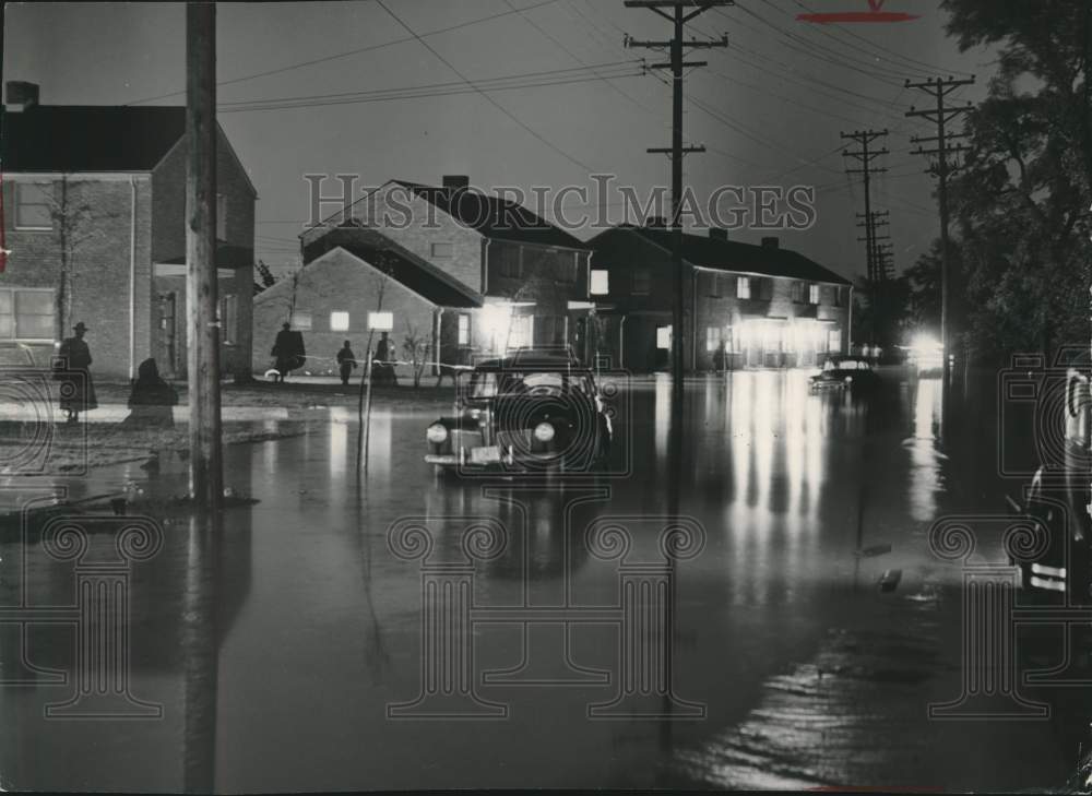 1953 car driving in flooded streets of Westlawn housing project, WI - Historic Images