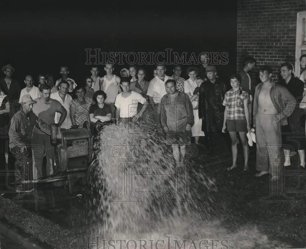 1949 crowd gathers to watch floodwaters be pumped from basements, WI - Historic Images