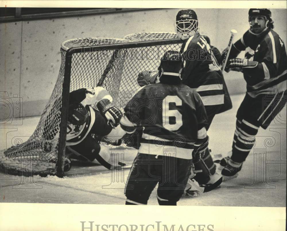 1984 Press Photo Milwaukee Admirals&#39; Chris Tanguay Follows Puck Into Hockey Net - Historic Images