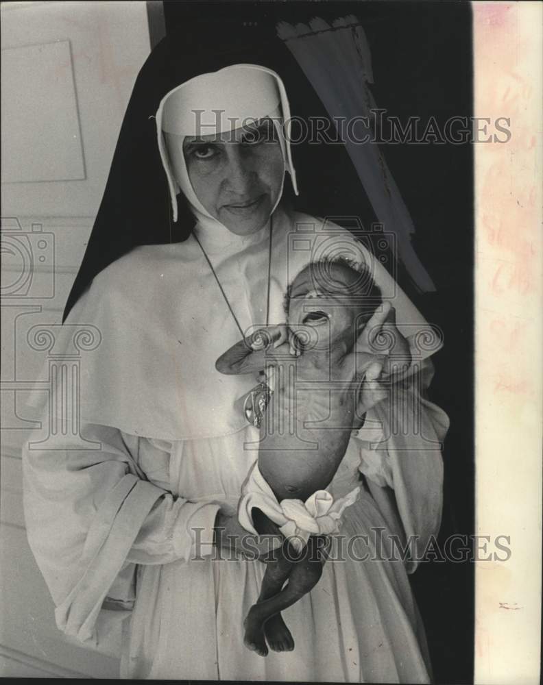 1962 Sister Dulce with a starved infant in Brazil - Historic Images