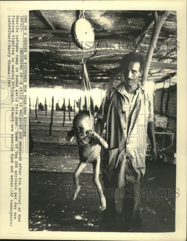 1985 Press Photo Child is Weighed at Wad Sherife Refugee Camp, Sudan - mjc40649 - Historic Images