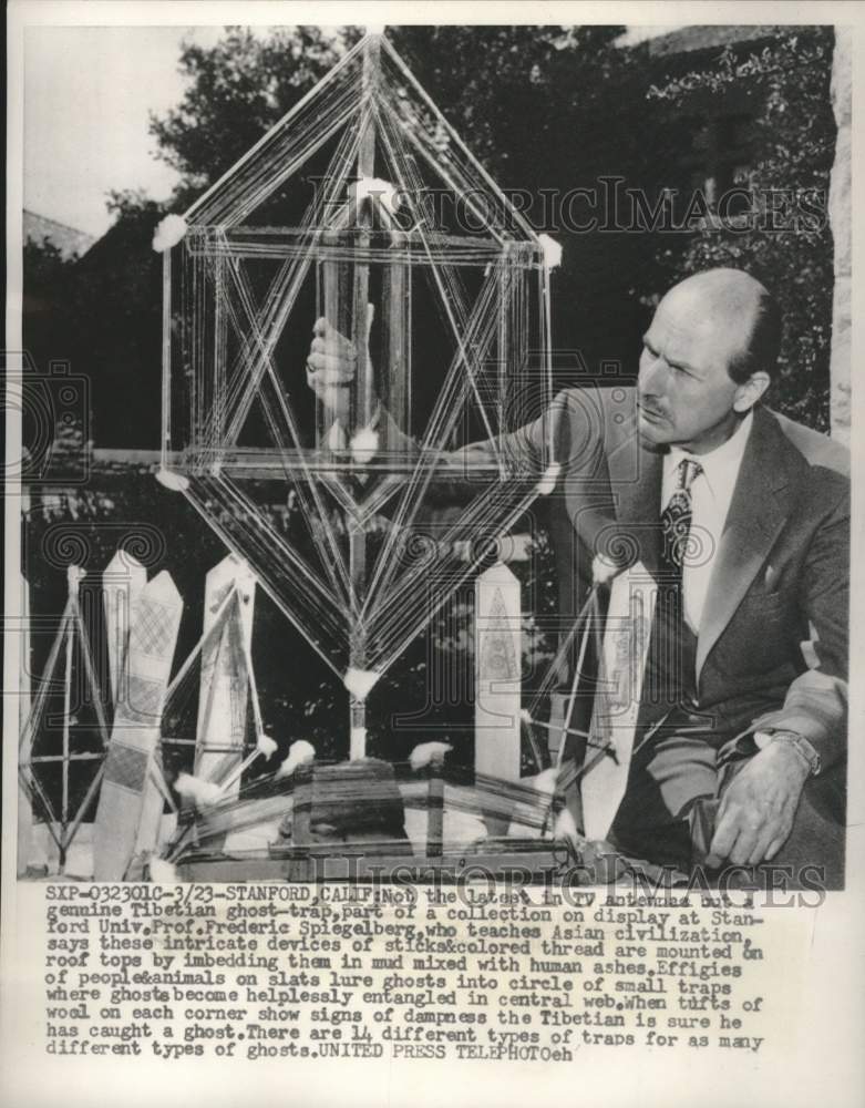 1955, Professor Frederic Spiegelberg exams a Tibetan ghost-trap. - Historic Images