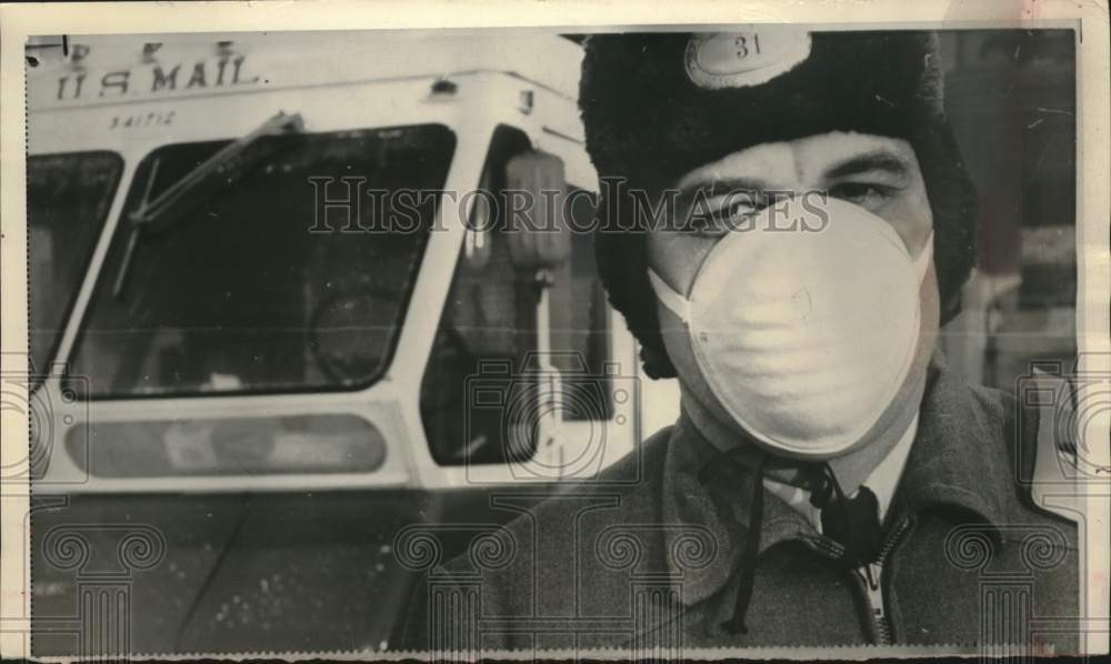 1965, Oshkosh Wisconsin mail carrier Richard Bahn tests new cold mask - Historic Images