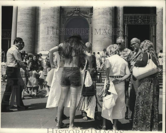 1971, Tourists cover up to enter St. Peter's cathedral in Rome - Historic Images