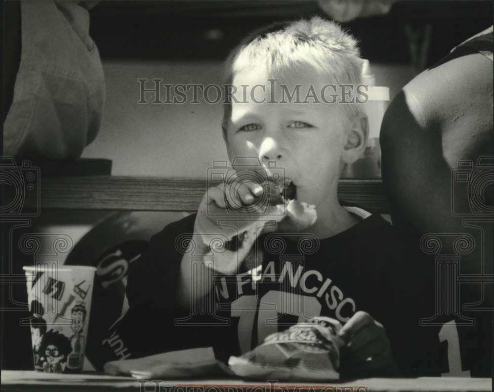 1994 Press Photo Jack Buochke, West Allis, enjoys hot dog at Special Olympics. - Historic Images