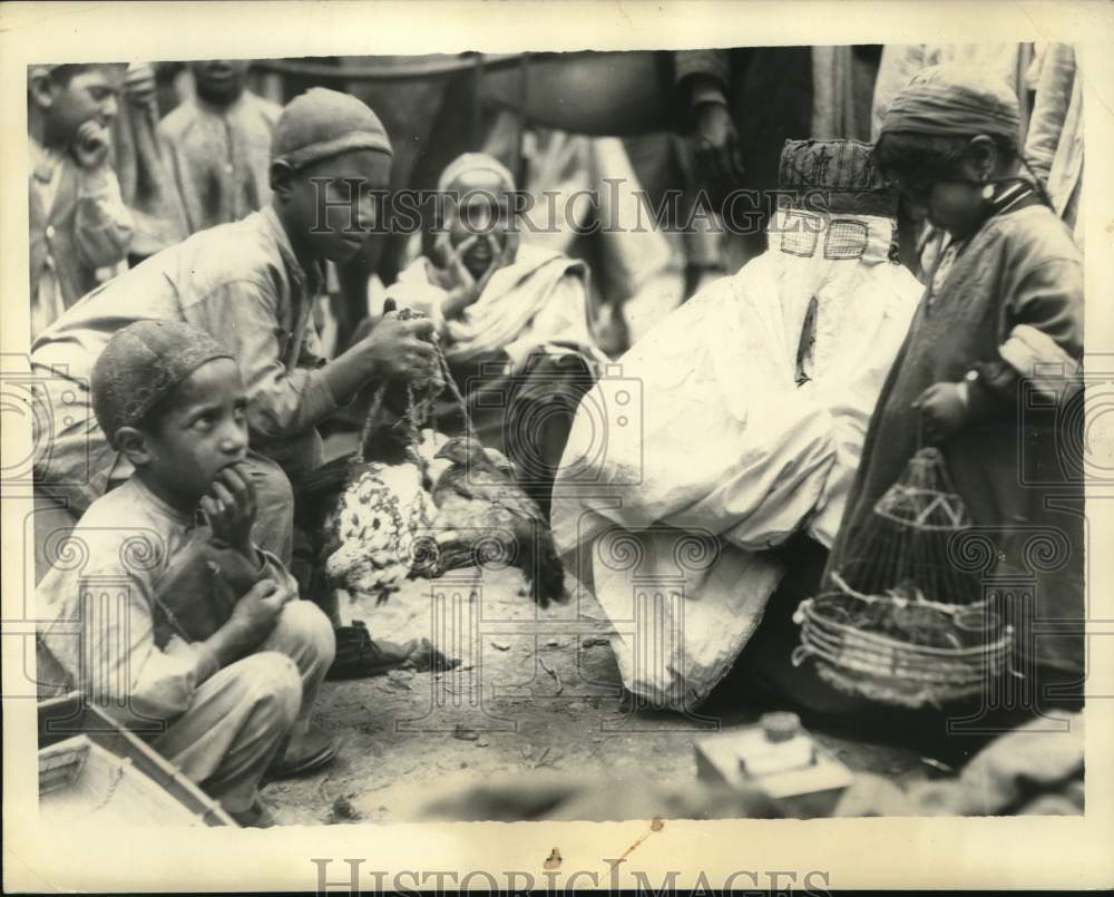 1933, Indian Woman Under Sheet Checks Chickens at Peshawar Market - Historic Images