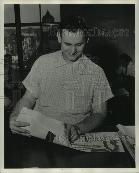 1953, Rudolph Valla places proofs of ad into a proof envelope - Historic Images