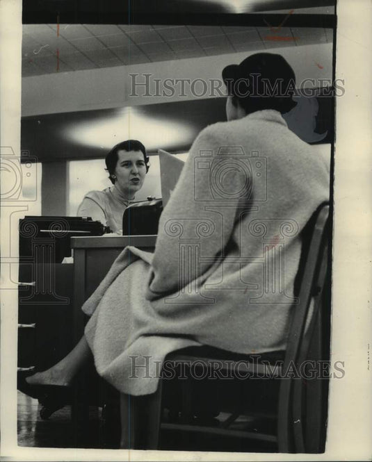 1954, The Milwaukee Journal's Carol Jensen talks with a client - Historic Images