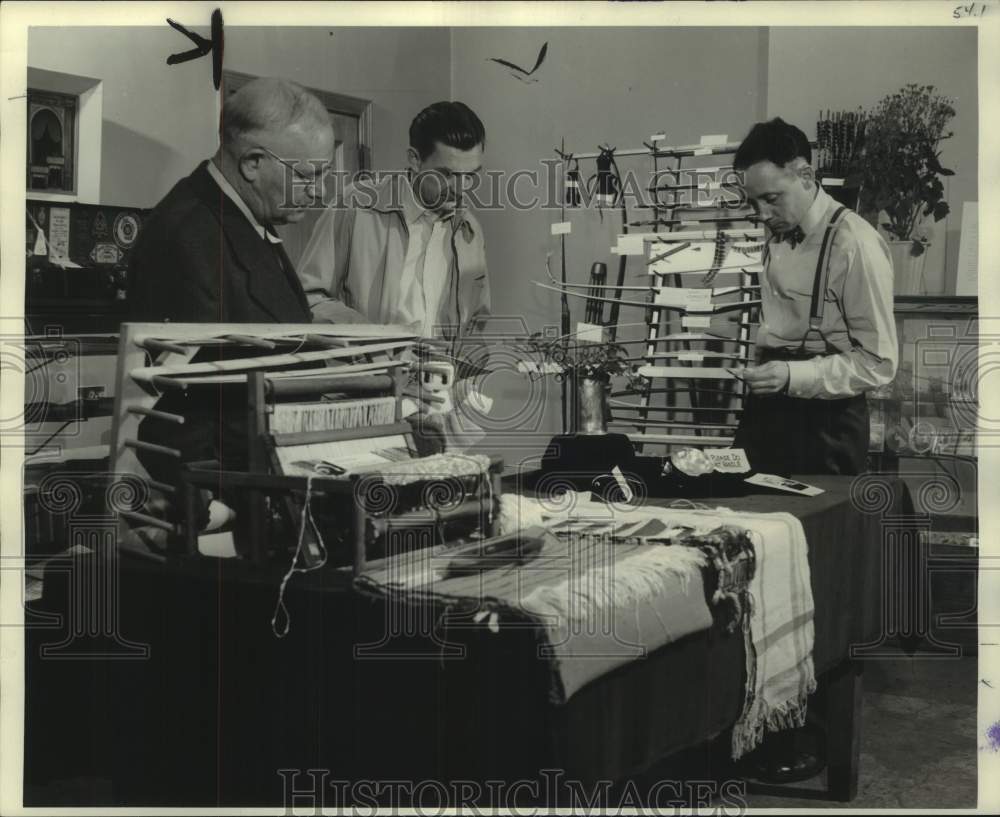 1951 Men look at Archery equipment at Milwaukee Journal Hobby Show - Historic Images