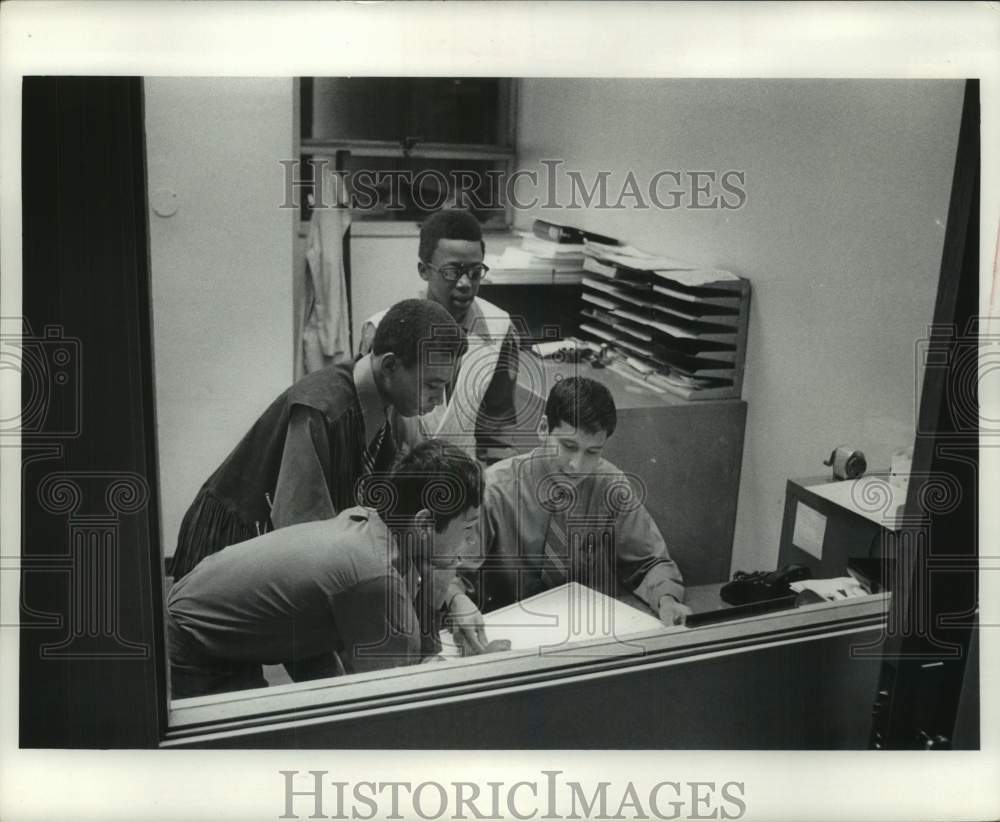 1970, The Milwaukee Journal Newsboys gather at a desk, Wisconsin - Historic Images