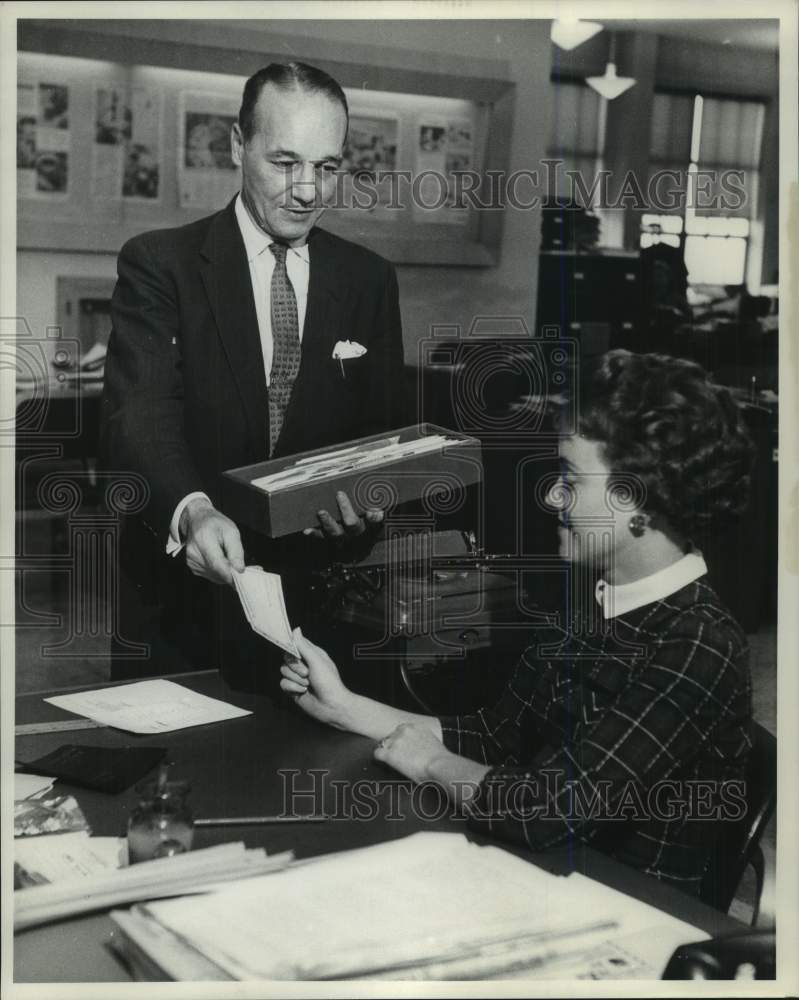 1960 Frank Miller hands out Milwaukee Journal payroll checks, WI - Historic Images