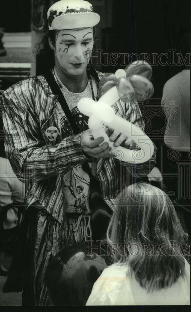 1994 Press Photo Kid waits for hat from Balloon man S. Clarke, Rainbow Summer WI - Historic Images