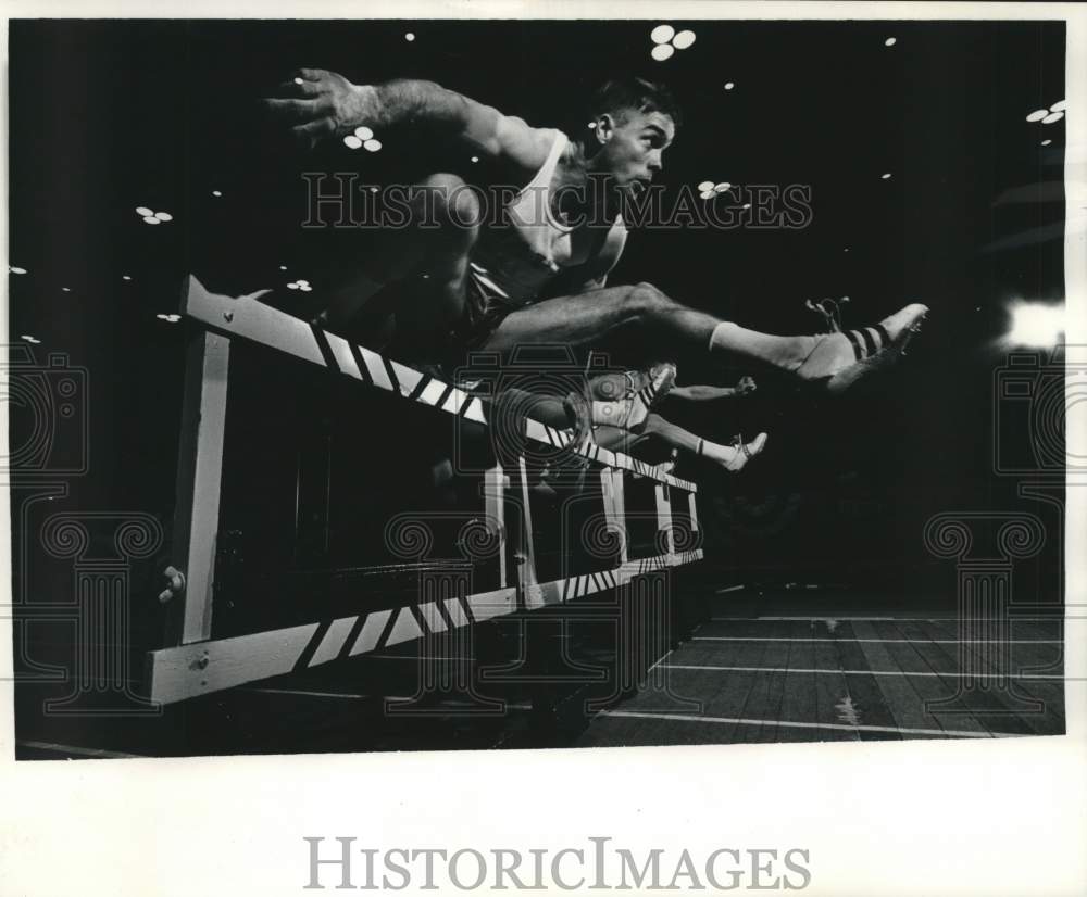 1965 C.P. Gray jumps a hurdle, Milwaukee Journal track games, WI - Historic Images