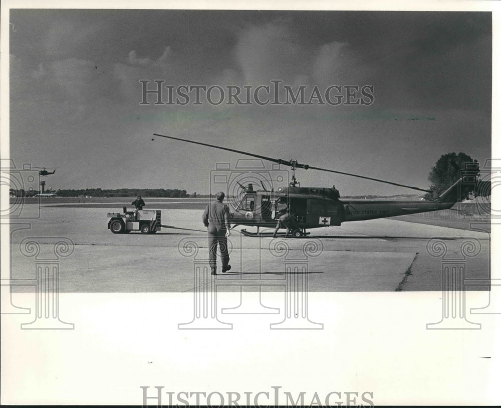 1985 National guard helicopter being towed to hangar, Wisconsin-Historic Images