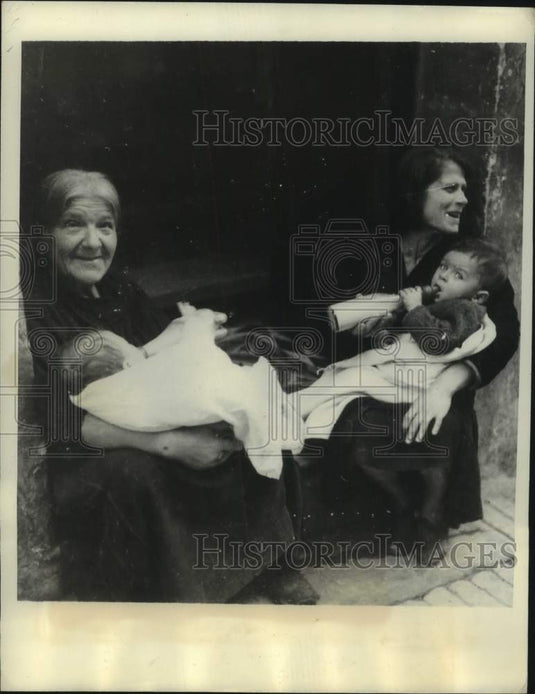 1943 Mothers on the island of Malta feed their babies and smile - Historic Images