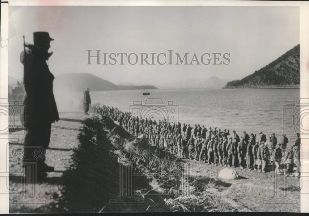 1951 UN guards watch Red prisoners clean up landslide in Korea.-Historic Images
