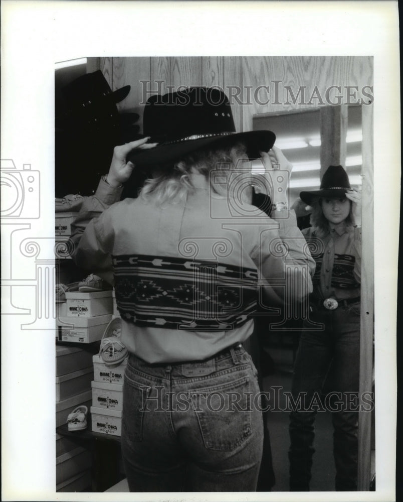 1993, Tracey Zsido tries on a hat at The Cowboy&#39;s Store. - mjp12358 - Historic Images