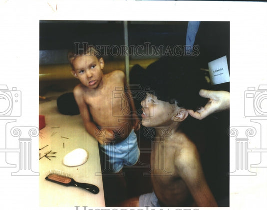 1993, Children cast in Florentine Opera, "Aida" are fitted for wigs. - Historic Images