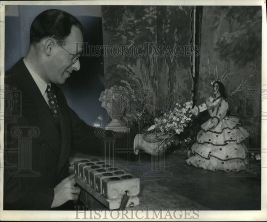 1940 Press Photo Dr. Julius Ehrlich gives flower to World Opera lady puppet. - Historic Images