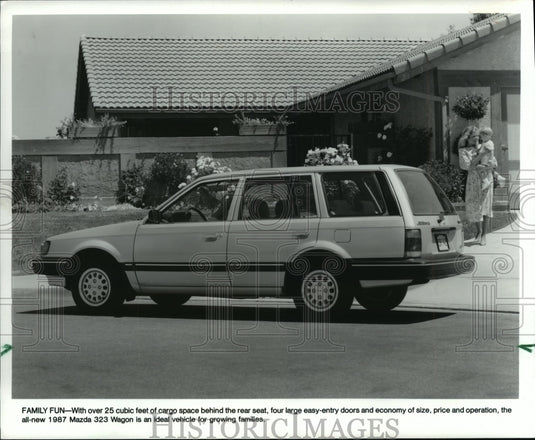 1986 Press Photo In front of home sits new 1987 Mazda 323 Wagon - mjp17429 - Historic Images