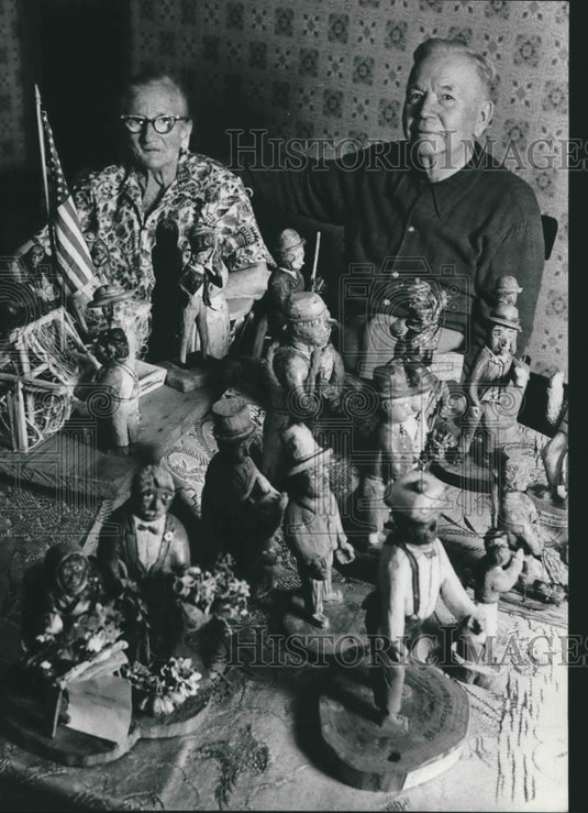 1975 Mr.and Mrs. John Mickowski with several of his wood carvings. - Historic Images