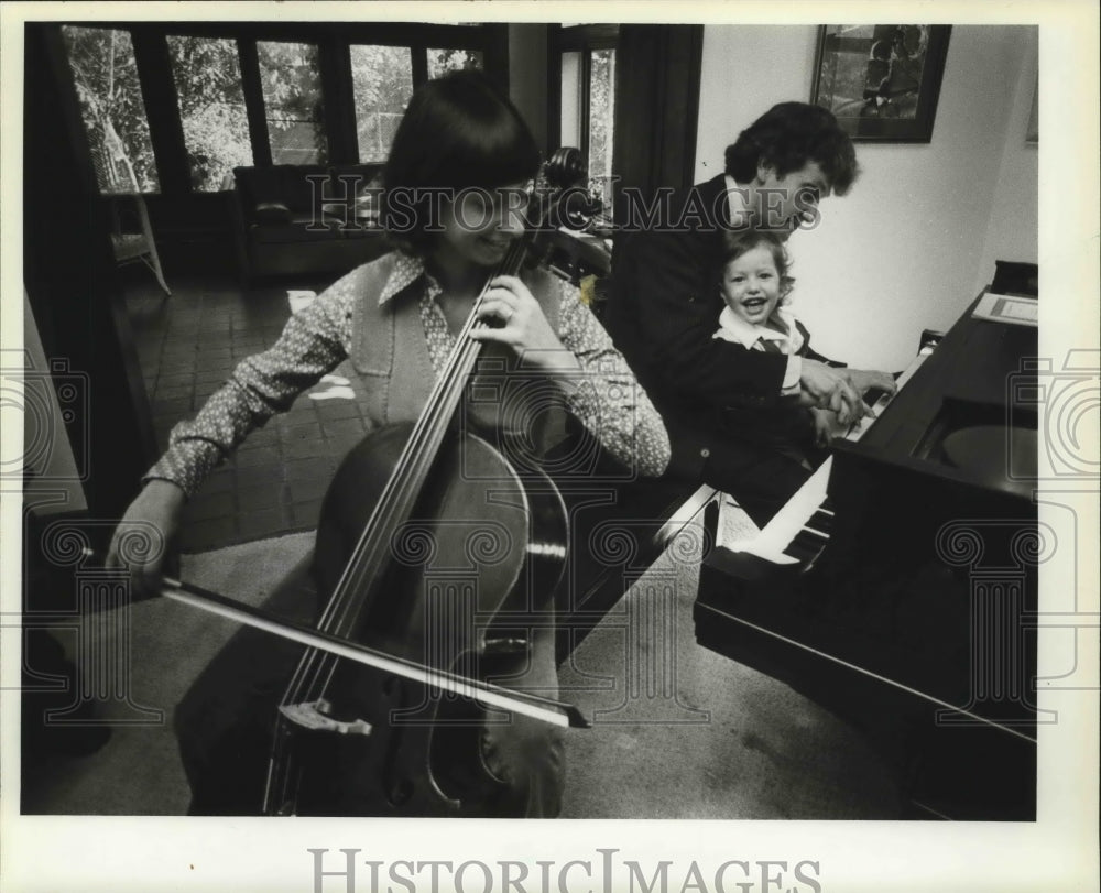 1982, Jane and Jeffrey Hollander play music with their son, Jamie - Historic Images