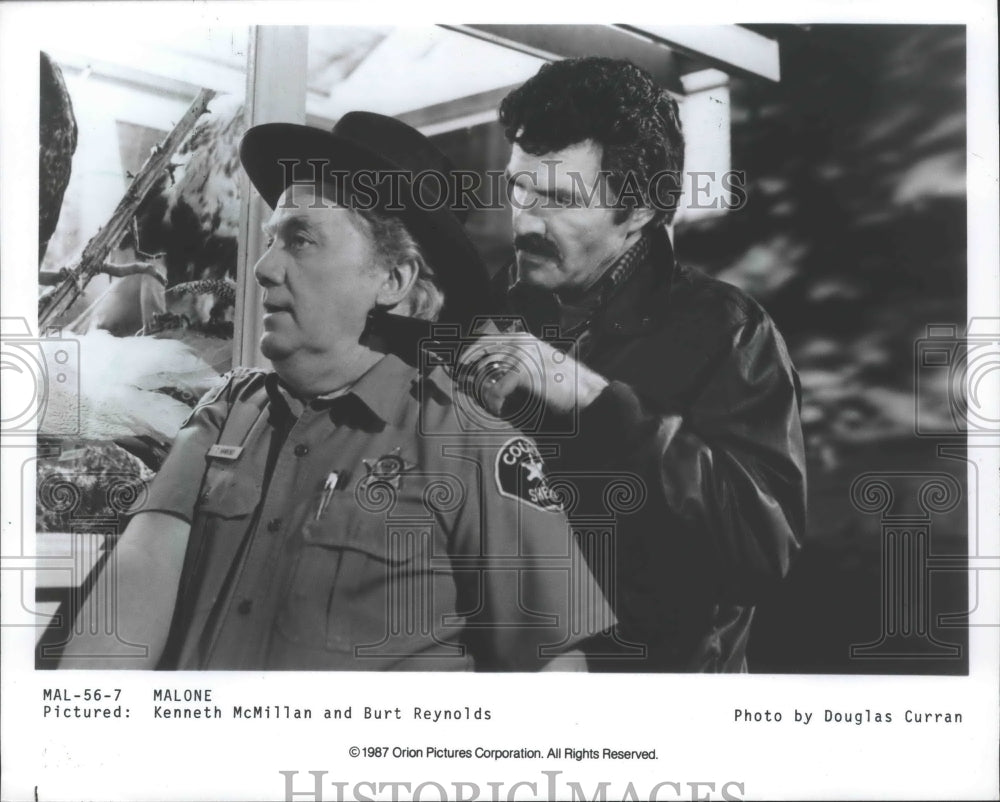 1987, Actor Burt Reynolds, Kenneth McMillan in "Malone" - mjp20355 - Historic Images