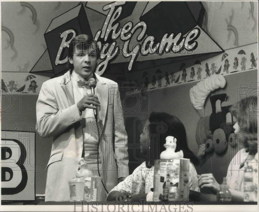 1989, Host of "The Baby Game" and contestants during game show taping - Historic Images