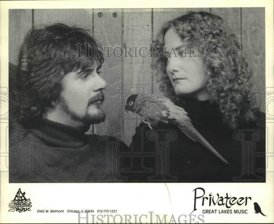 1991, Tom & Christ Kastle of band "Privateer" pose with parrot - Historic Images